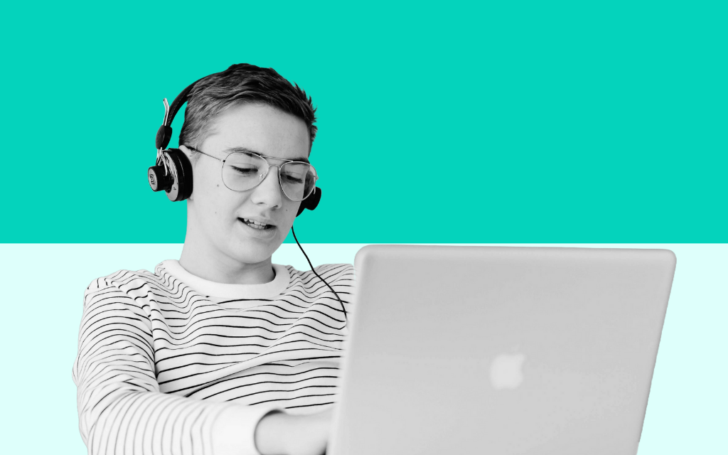Young man working at a computer, developing employability and work-ready skills in a modern workplace environment