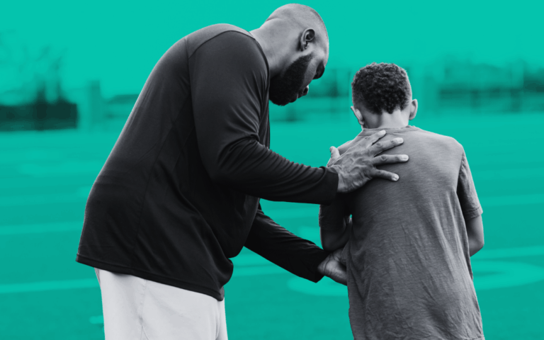 Learner coaching a child during a sports activity session, representing positive learning communities, safeguarding and inclusive education environments