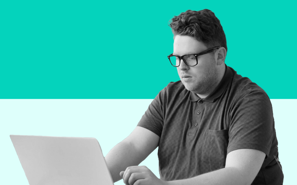 Man working at a laptop representing professional development and accountability in apprenticeship programmes at Educationwise
