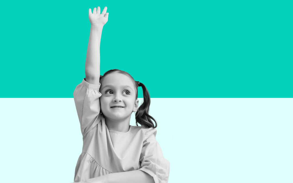 Child learning in a classroom supported by teaching assistants and school staff as part of a positive educational environment