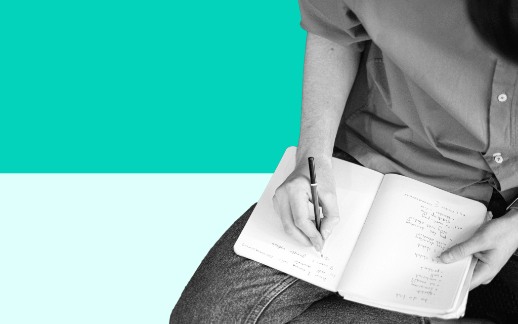 A learner sitting at a desk writing structured revision notes by hand in a notebook, using colour coding and clear headings to organise their study materials for a Level 2 Maths qualification with Additional Learning Support from Educationwise.